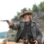 Jeff Bridges portraying Rooster Cogburn in True Grit (2010), wearing the original weathered brown fedora that inspired the replica hat.