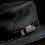 Close-up of the handcrafted distressed black felt replica hat inspired by Devil Anse Hatfield from the Hatfields & McCoys series, showing hatband and texture details.