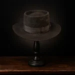 Front view of the handcrafted brown felt replica hat inspired by Margaret Dutton from the series 1883, displayed on a wooden stand.